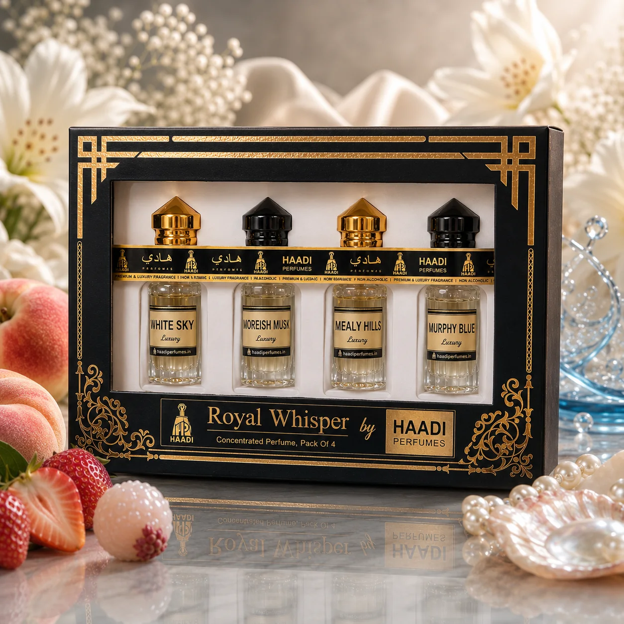 Haadi Royal Whisper perfume oil gift set, styled with fruit and pearls